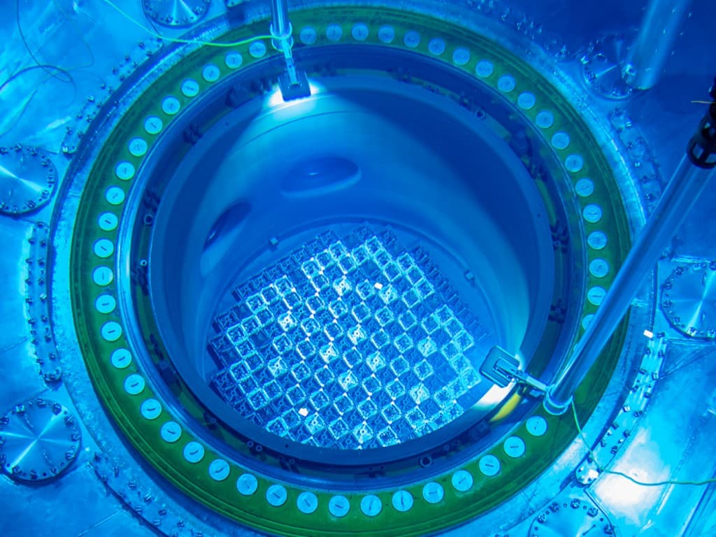 Reactor core glowing blue with Cherenkov radiation in a fuel pool